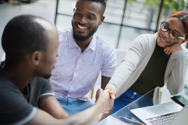 African business people handshaking at modern office