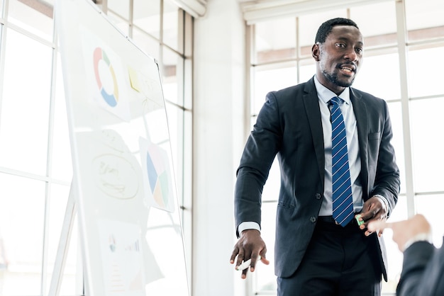 African businessman presents and listen to opinions at a business group meeting