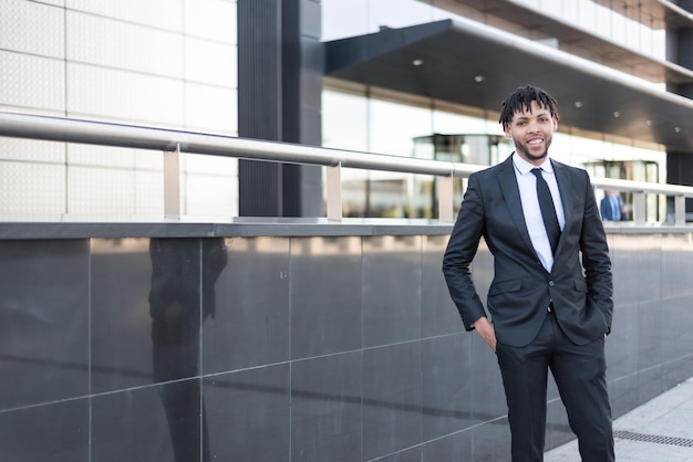 African businessman in suit at street