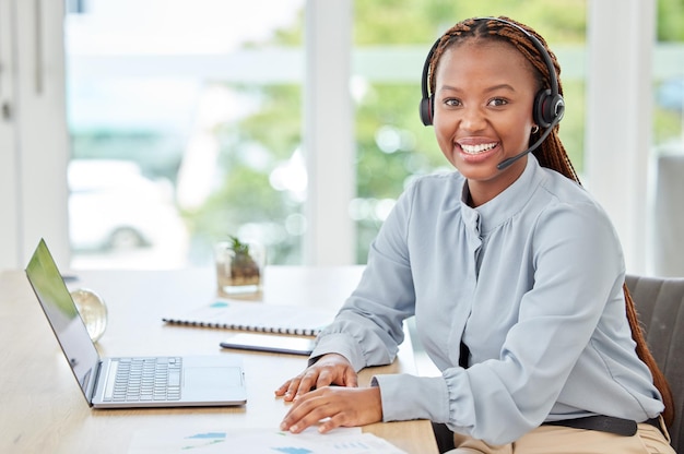 Photo african call center worker in telemarketing communication with people online on laptop and consultant working in crm at startup agency portrait of customer service employee consulting on internet