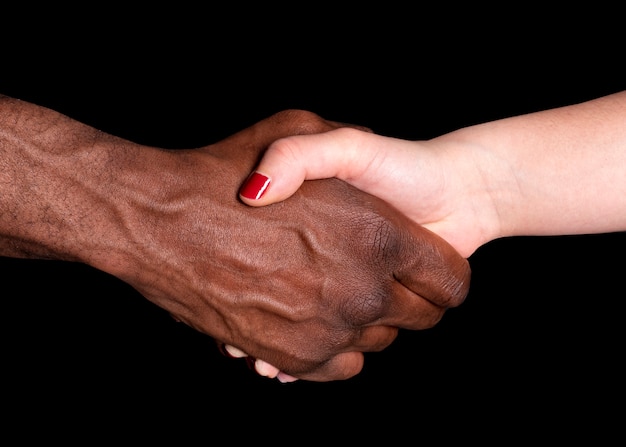 African and Caucasian hands together