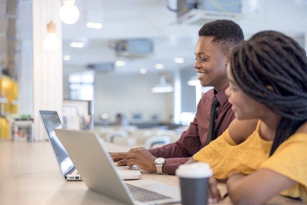 African college university students using laptop together