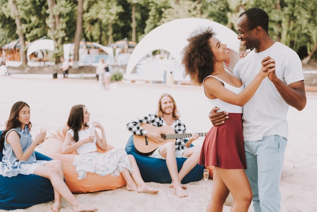 African couple dance salsa on beach chitarra musicale.