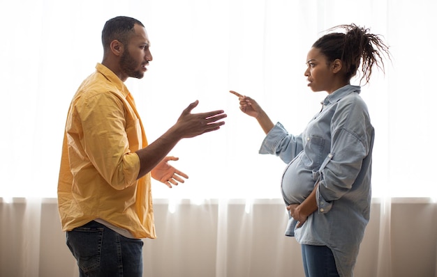 African Couple Having Quarrel Shouting At Each Other At Home