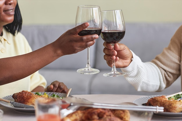 African couple toasting with red wine