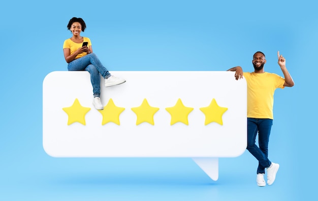 Photo african couple using phone posing with rating icon blue background