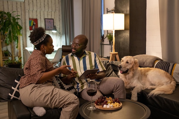 African couple using tablet pc at home