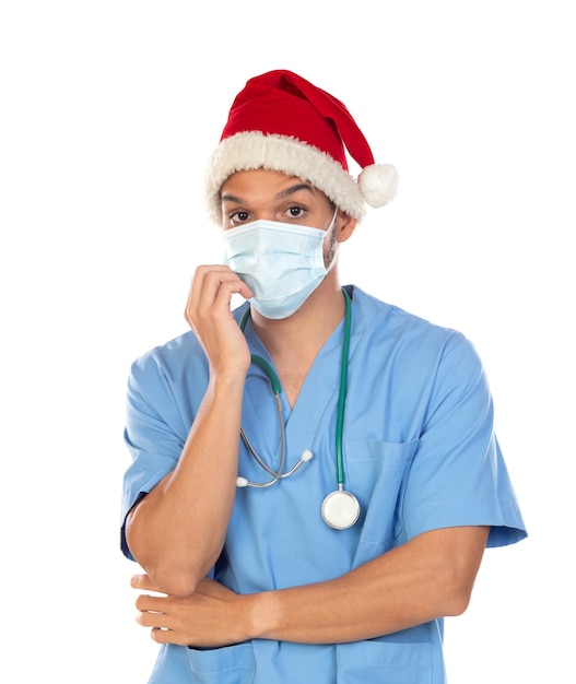 흰색 배경에 고립 된 코로나 바이러스 시간에 크리스마스 모자를 쓰고 아프리카 의사