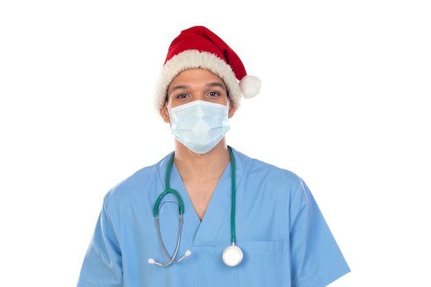 African doctor wearing a Christmas hat at coronavirus time isolated on a white wall