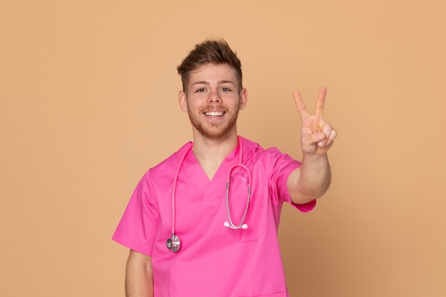 African doctor wearing a pink uniform on a yellow background