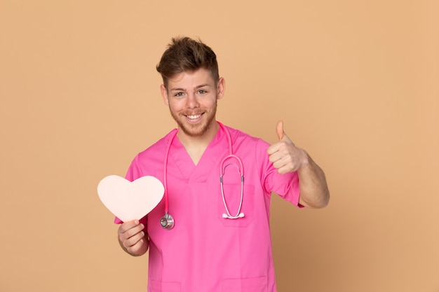 African doctor wearing a pink uniform on a yellow background