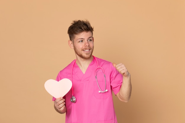 African doctor wearing a pink uniform on a yellow background