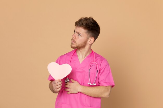 African doctor wearing a pink uniform on a yellow background