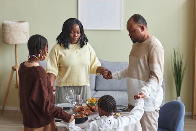 African family prayng before dinner