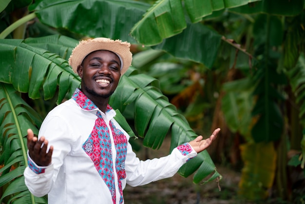 Premium Photo | African farmer man standing with banana tree in organic ...