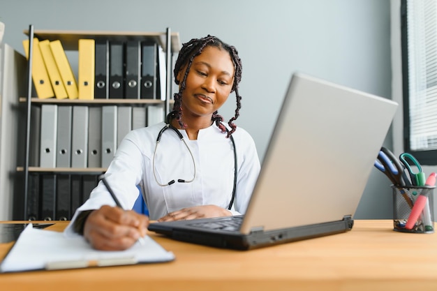 African female doctor make online telemedicine video call\
consult patient afro american black woman therapist talking to\
camera in remote videoconference chat webcam view face\
headshot