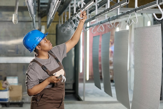 African female worker working with products at factory