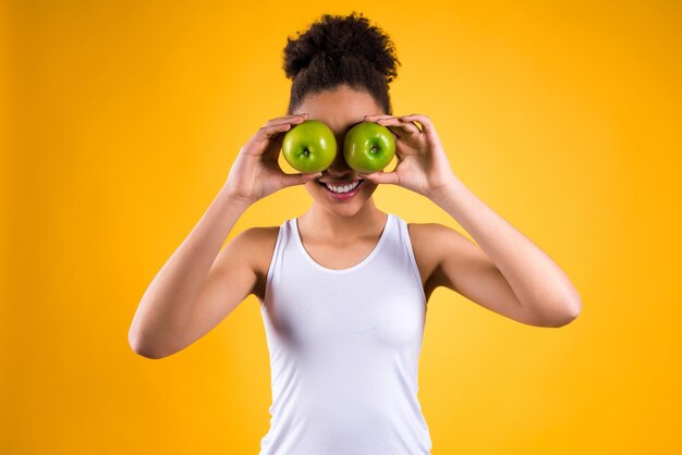 African girl closed her eyes with apples