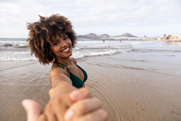 African girl walking happily on the beach