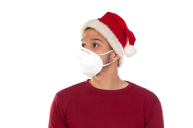 African guy wearing a christmas hat and a mask isolated on a white background