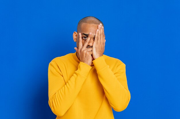 African guy with yellow sweatshirt