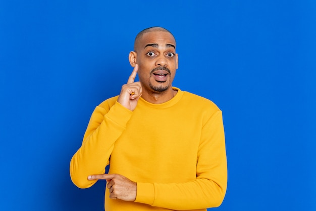 African guy with a yellow sweatshirt