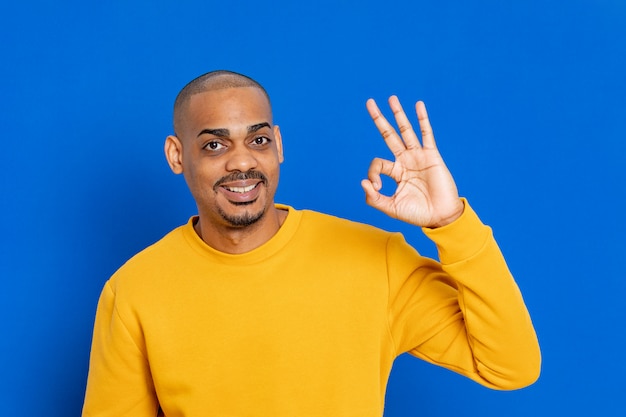 African guy with a yellow sweatshirt