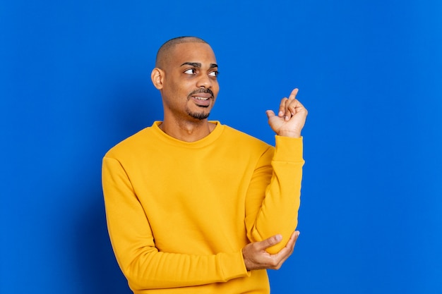 African guy with a yellow sweatshirt