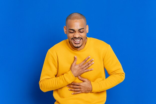 African guy with a yellow sweatshirt