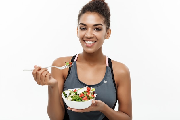 African healthy Lady eating fresh Salad