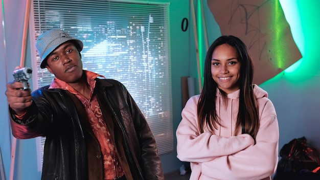 African male and female film stars smiling to the camera man showing his fun