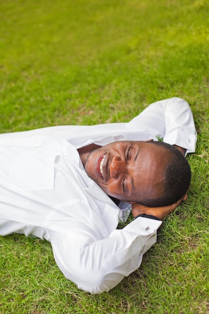 African man lying down on the grass