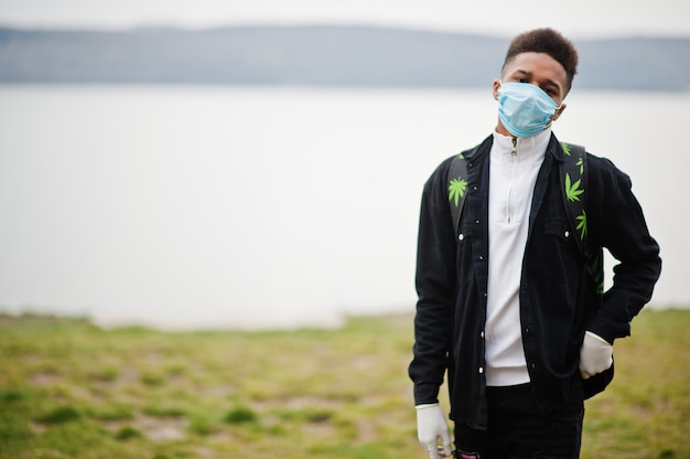 African man at park wearing medical masks protect from infections and diseases coronavirus virus quarantine.