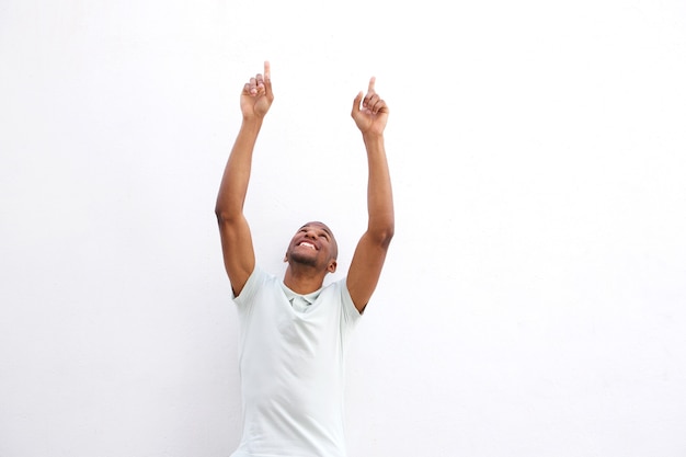 African man pointing up on white background