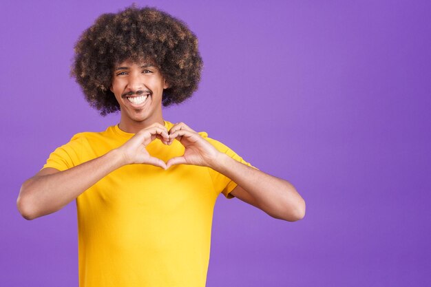 African man representing a heart in the shape of fingers