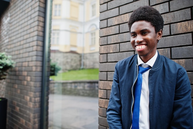 African man wear in tie and casual outfit posing outdoor.