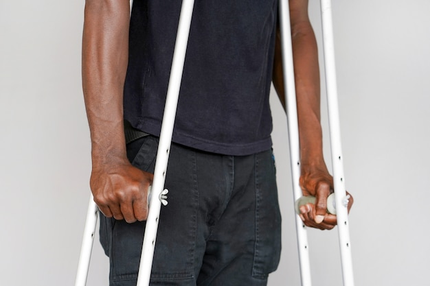 African man with crutch. Close-up. Side view