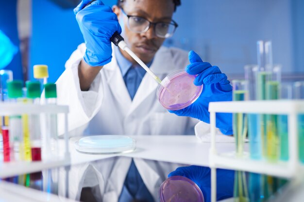 African Scientist Holding Petri Dish