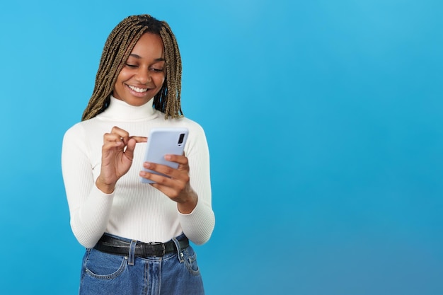 African smiling woman using the mobile phone