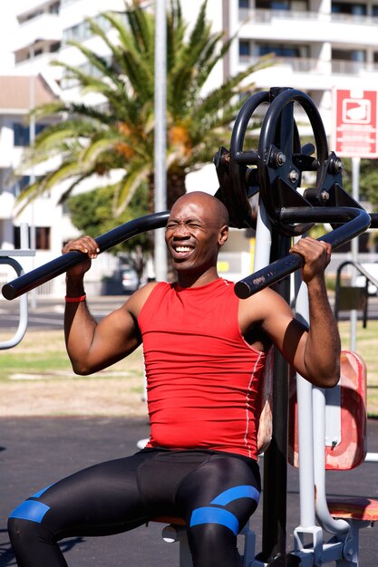 African sports man exercising with equipments on the park