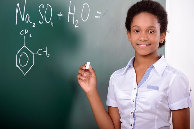 African student doing math problems on the chalkboard