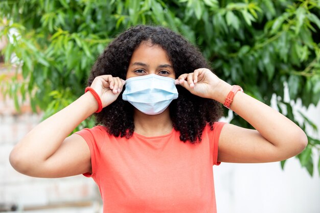 African teenager wearing a mask in order to protect hemself of the virus