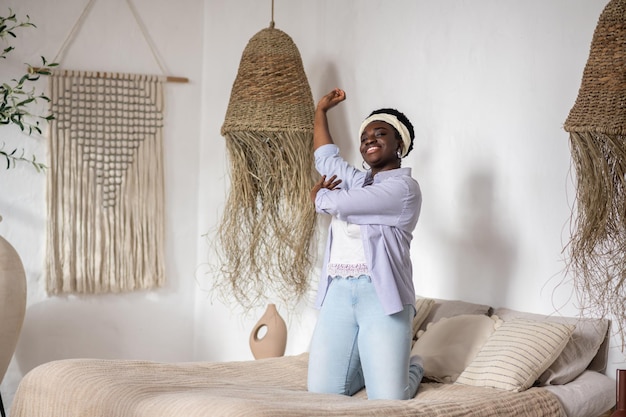 African woman in a bedroom with ethnic interior