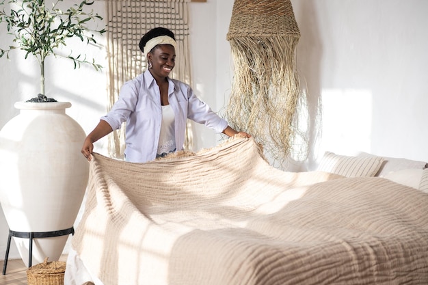 African woman in a bedroom with ethnic interior