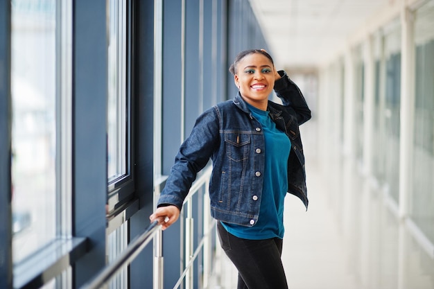 African woman in jeans jacket posed indoor