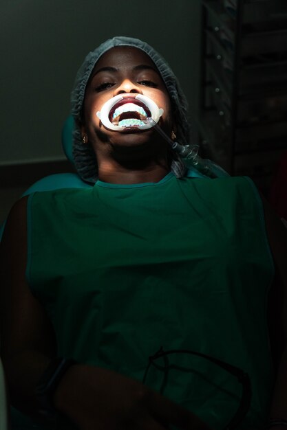 African woman sitting in the dentist's chair.