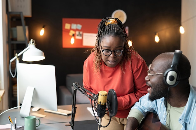 African young couple recording the song together