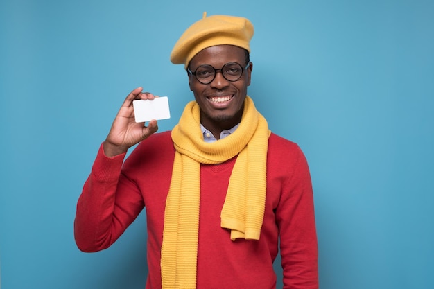 African young man bank manager showing credit card for online shopping