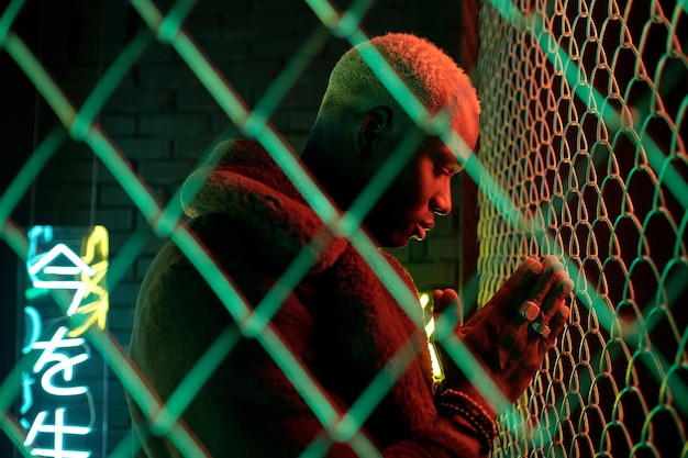 african young man in furcoat bowing with his hands put together in front of face