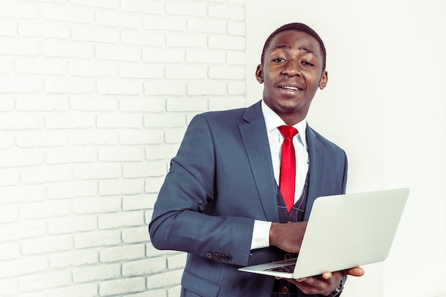 African young man holding laptop